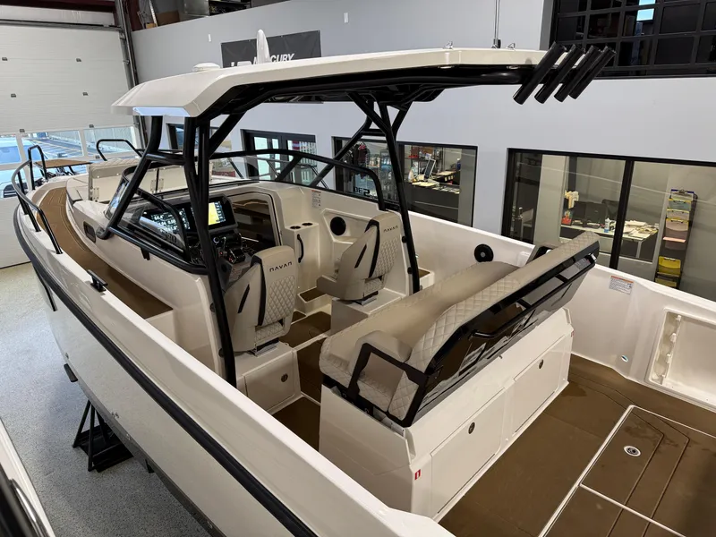Slide: The Image of Navan S30 2025 boat interior with seating and modern dashboard in showroom. - 29