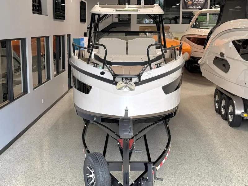 Slide: The Image of 2025 Navan S30 boat displayed indoors on a trailer. - 3