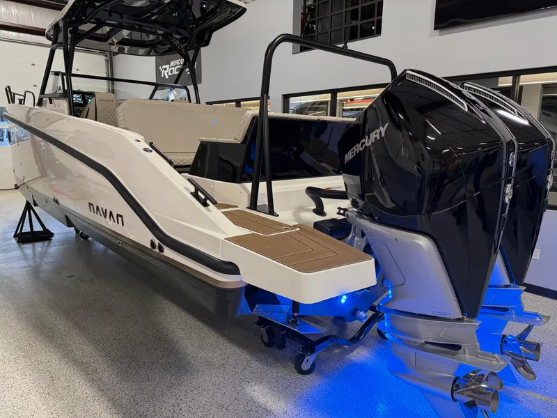 Slide: The Image of 2025 Navan S30 boat with dual Mercury outboard engines in showroom. - 32