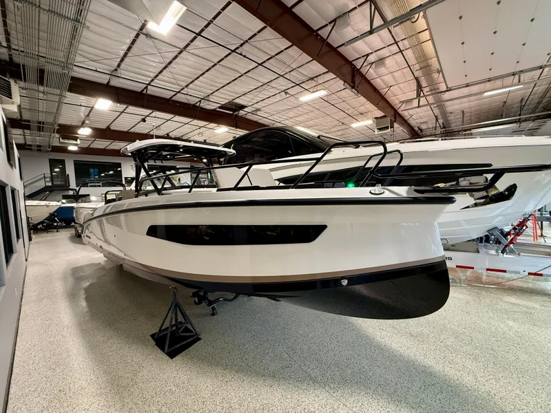 Slide: The Image of 2025 Navan S30 boat displayed in a spacious indoor showroom. - 37