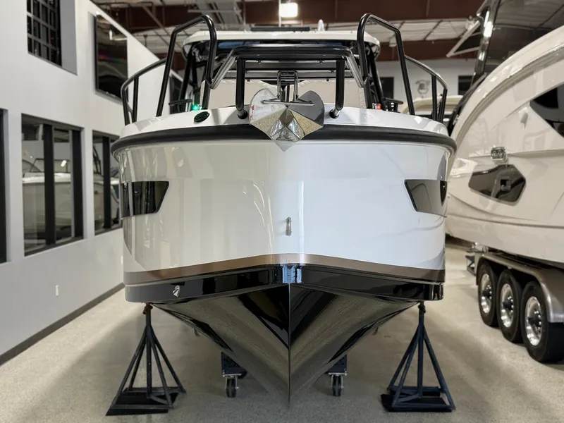 Slide: The Image of 2025 Navan S30 boat displayed indoors on stands, front view. - 38