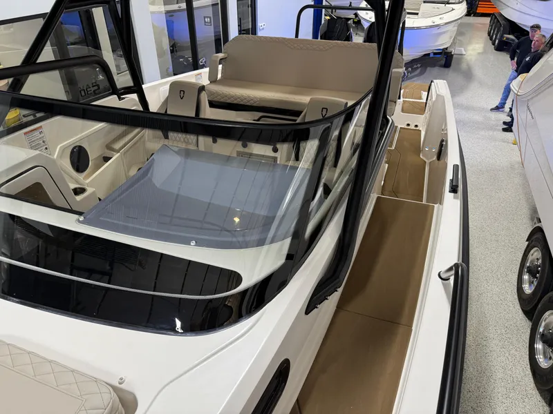 Slide: The Image of Navan S30 2025 boat interior with seating and windshield, displayed in showroom. - 47
