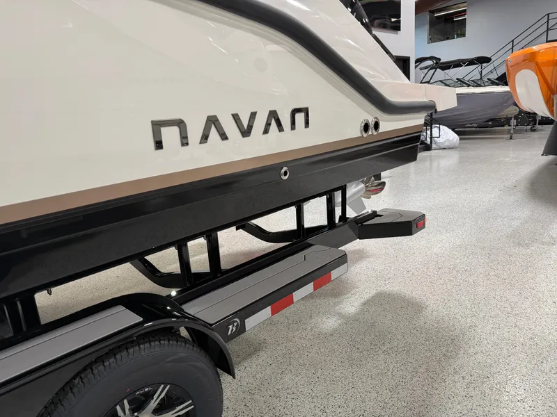 Slide: The Image of Navan S30 2025 boat on trailer in showroom, featuring sleek design and modern aesthetics. - 8