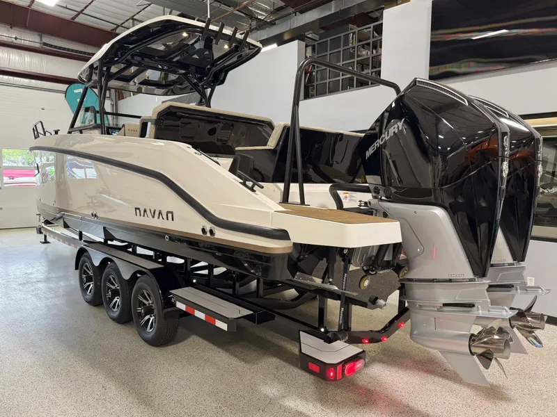 Slide: The Image of 2025 Navan S30 boat on trailer with dual Mercury outboard engines in showroom. - 9