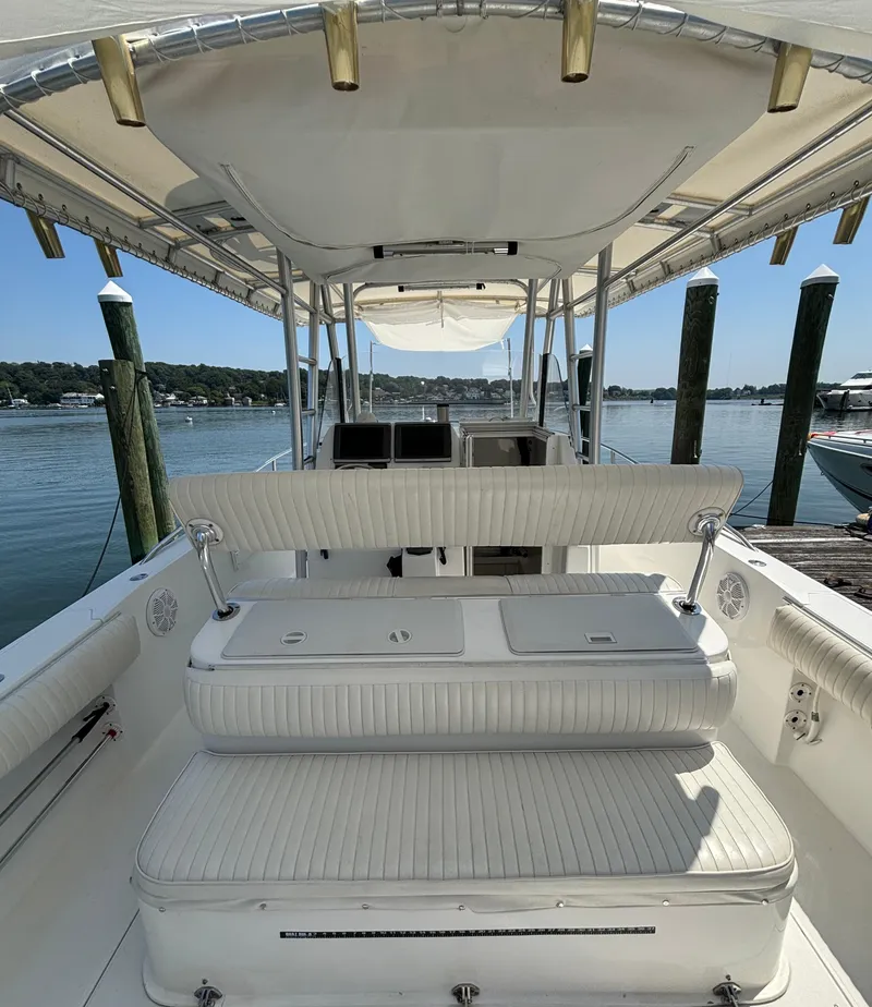 Slide: The Image of 2005 Stamas 310 Tarpon boat interior with seating, docked by calm waters. - 11