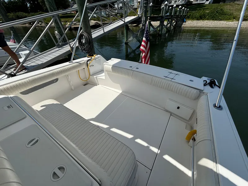 Slide: The Image of 2005 Stamas 310 Tarpon boat interior with seating, docked by a pier. - 15
