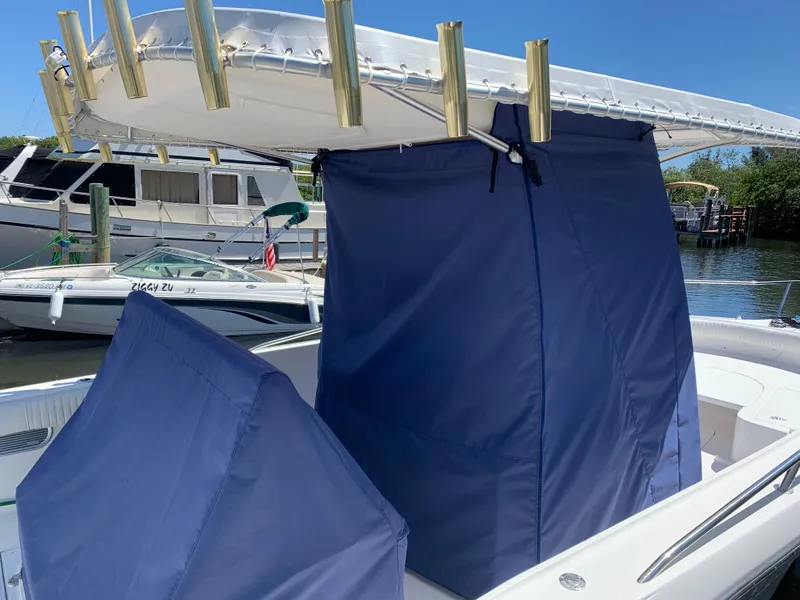 Slide: The Image of 2005 Stamas 310 Tarpon boat with blue covers docked at marina. - 18
