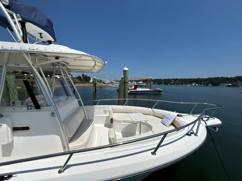 Slide: The Image of 2005 Stamas 310 Tarpon boat docked in a serene marina setting. - 4