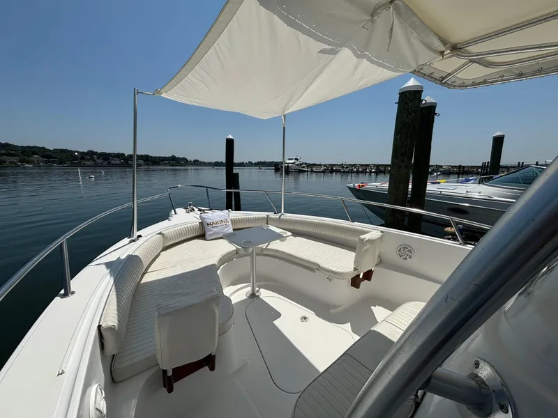 Slide: The Image of 2005 Stamas 310 Tarpon boat with shaded seating area, docked in a serene marina. - 6