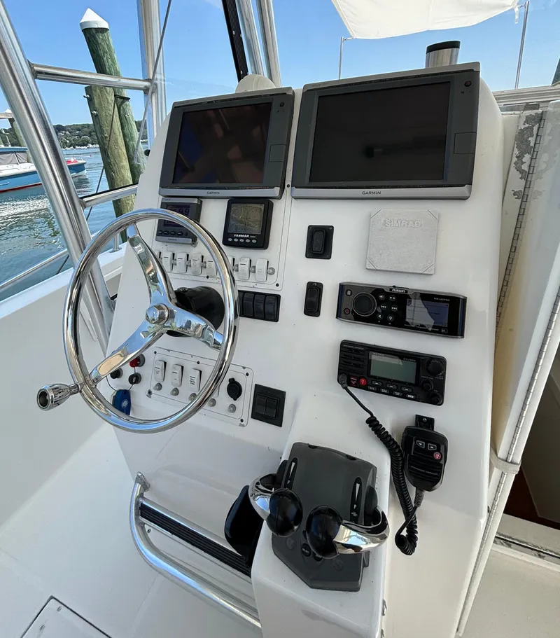 Slide: The Image of Control panel of a 2005 Stamas 310 Tarpon boat with navigation equipment. - 8