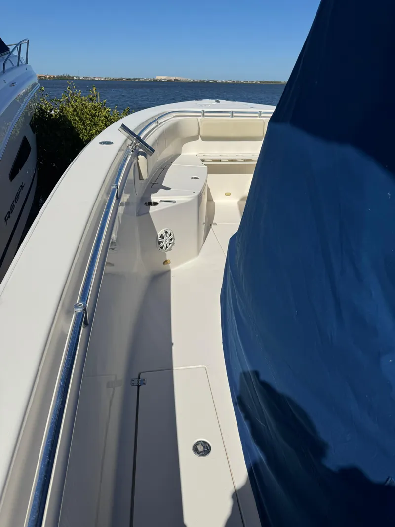 Slide: The Image of 2013 Cobia 296 Center Console boat docked by the water. - 16