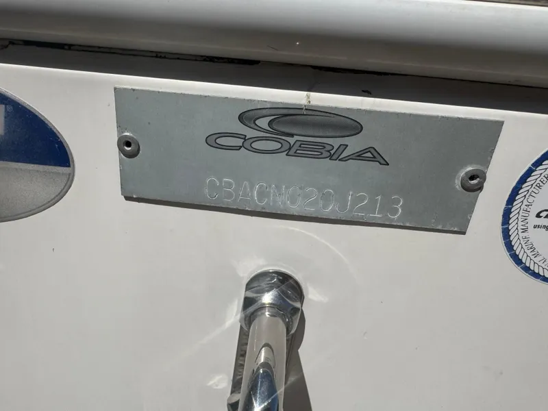 Slide: The Image of 2013 Cobia 296 Center Console boat identification plate with engraved serial number. - 23