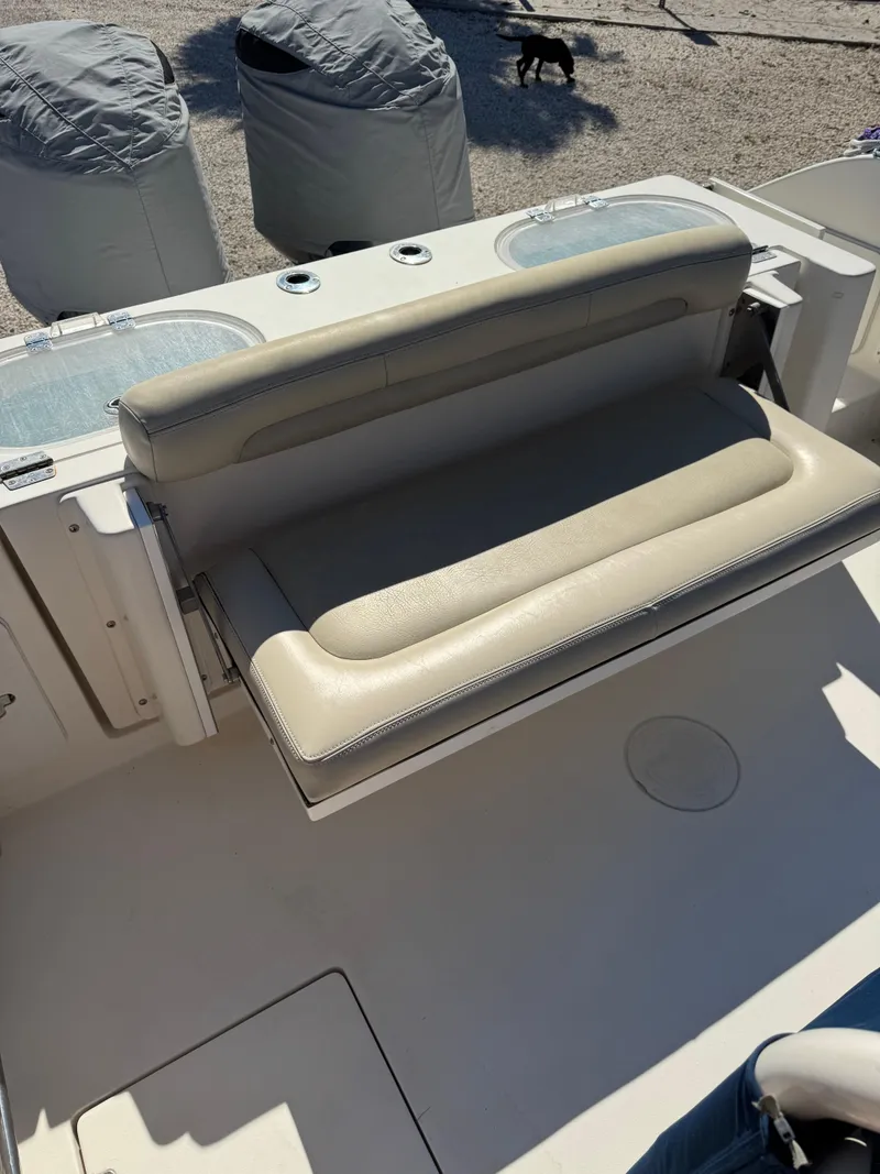 Slide: The Image of 2013 Cobia 296 Center Console boat with cushioned seating, outdoor setting. - 3