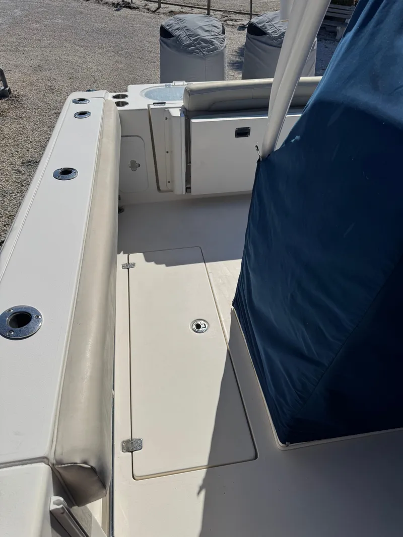 Slide: The Image of 2013 Cobia 296 Center Console boat deck with seating and storage. - 6