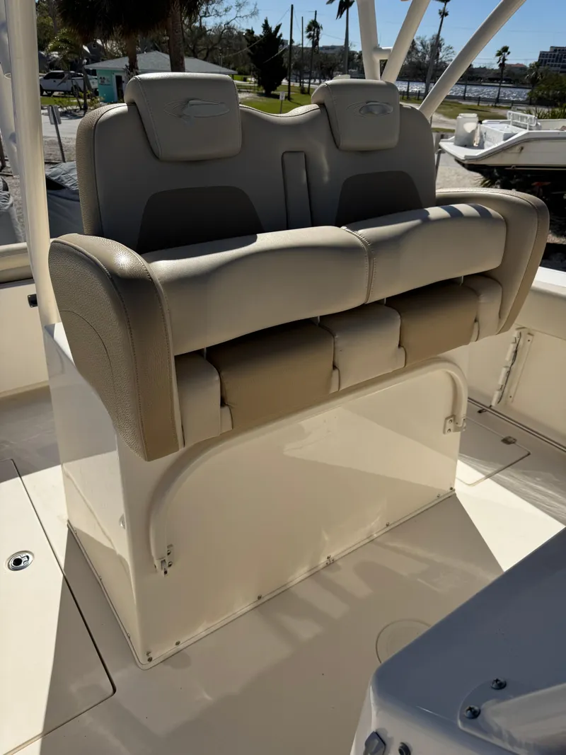 Slide: The Image of 2013 Cobia 296 Center Console boat seating area with cushioned seats. - 8
