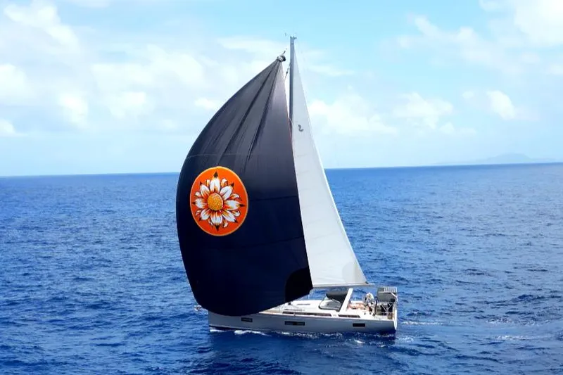 The Image of 2021 Beneteau Oceanis Yacht 54 sailing with a distinctive black sail on open sea. - 0