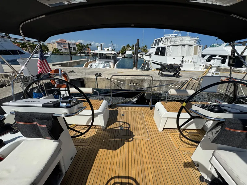 Slide: The Image of Cockpit view of 2021 Beneteau Oceanis Yacht 54, docked with dual steering wheels. - 10
