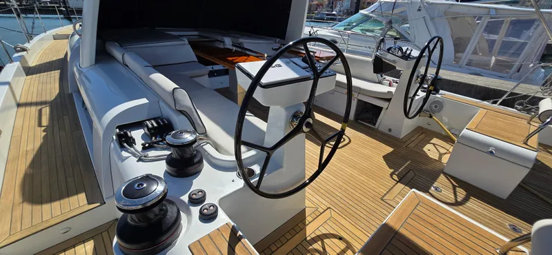 Slide: The Image of Cockpit of 2021 Beneteau Oceanis Yacht 54 with dual steering wheels and teak decking. - 15