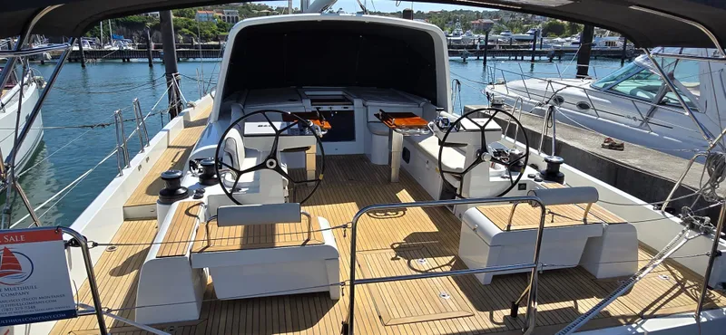 Slide: The Image of Beneteau Oceanis Yacht 54, 2021 model, featuring dual steering wheels and spacious deck. - 16