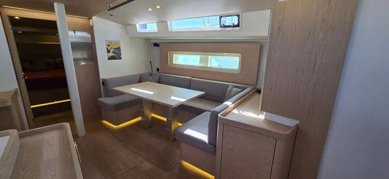 Slide: The Image of Modern interior of 2021 Beneteau Oceanis Yacht 54 with sleek dining area and ambient lighting. - 20