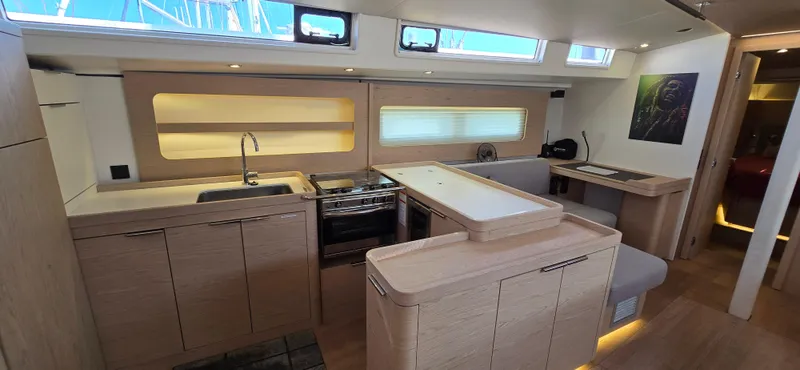 Slide: The Image of Modern interior of 2021 Beneteau Oceanis Yacht 54 with sleek kitchen and dining area. - 21
