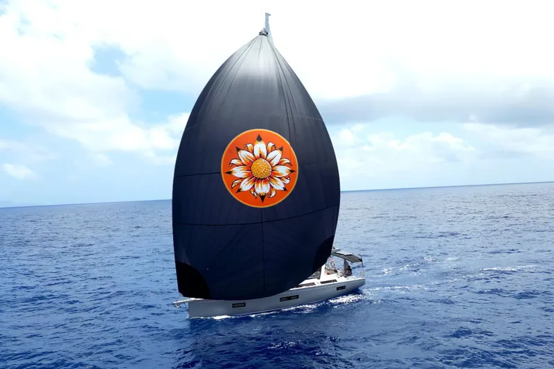 Slide: The Image of Beneteau Oceanis Yacht 54 sailing with a unique floral spinnaker on open sea, 2021 model. - 3