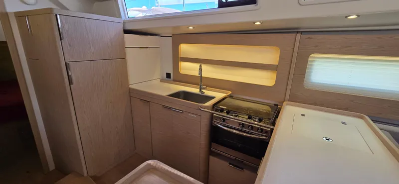 Slide: The Image of Modern kitchen in 2021 Beneteau Oceanis Yacht 54 with sleek cabinetry and appliances. - 30