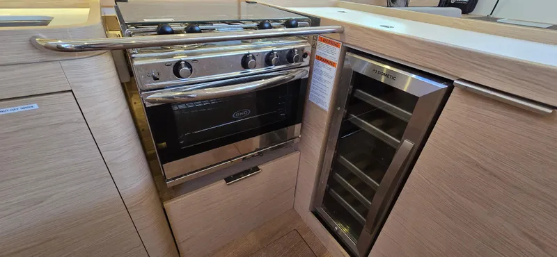 Slide: The Image of Modern kitchen in 2021 Beneteau Oceanis Yacht 54 with oven and wine cooler. - 32