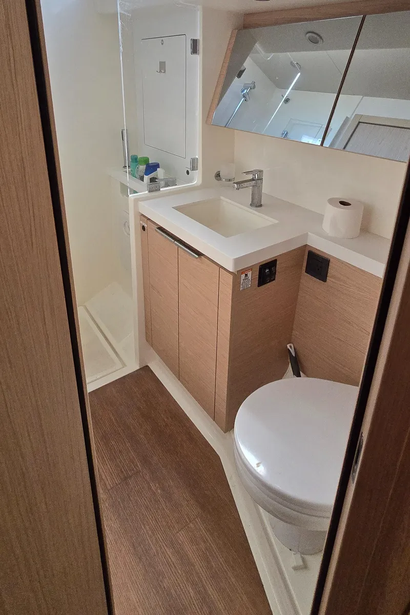 Slide: The Image of Modern bathroom in 2021 Beneteau Oceanis Yacht 54, featuring sleek fixtures and wood accents. - 34