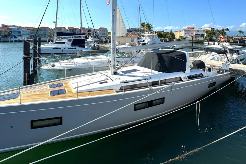 Slide: The Image of 2021 Beneteau Oceanis Yacht 54 docked in a marina, showcasing sleek design and modern features. - 6