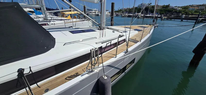 Slide: The Image of 2021 Beneteau Oceanis Yacht 54 docked in a marina, showcasing sleek design and modern features. - 7