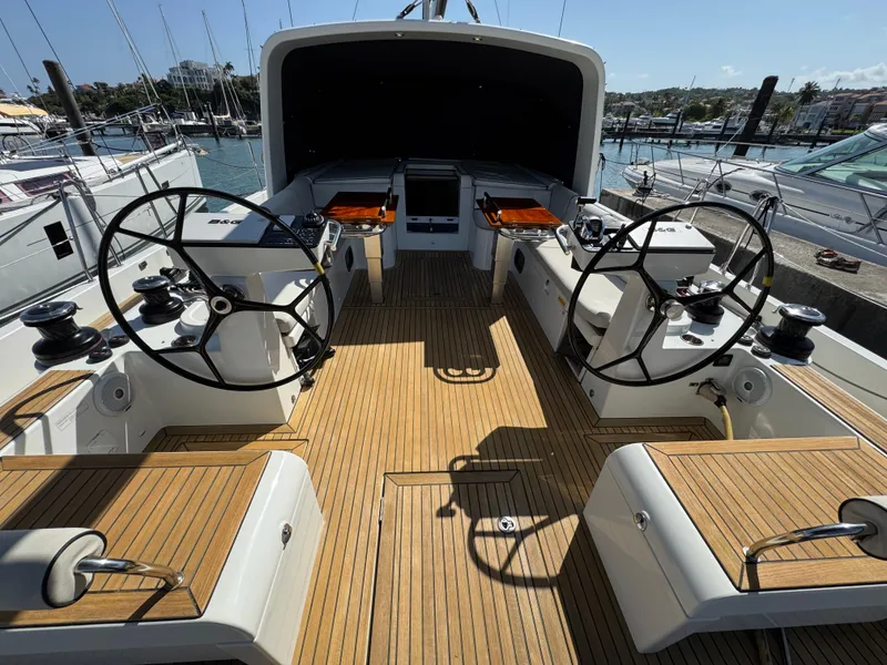 Slide: The Image of 2021 Beneteau Oceanis Yacht 54 cockpit with dual steering wheels and teak decking. - 9