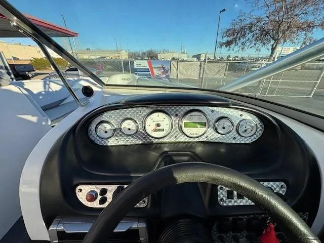 Slide: The Image of Dashboard of a 2004 MasterCraft X-30 boat with gauges and steering wheel. - 17