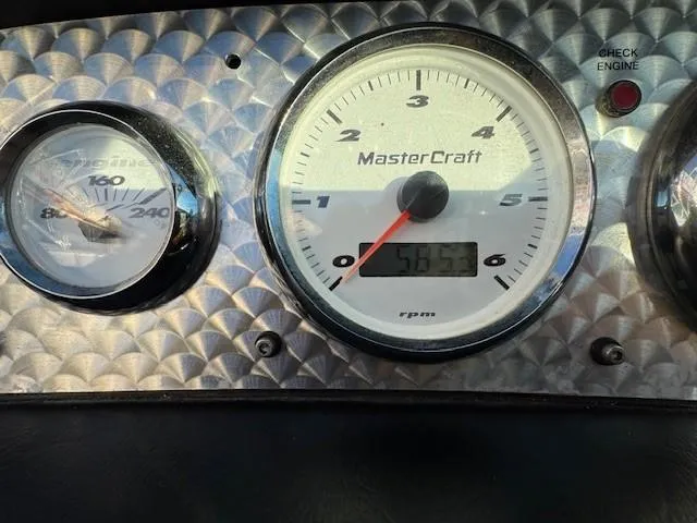 Slide: The Image of Dashboard gauges of a 2004 MasterCraft X-30 boat, showing RPM and temperature. - 18