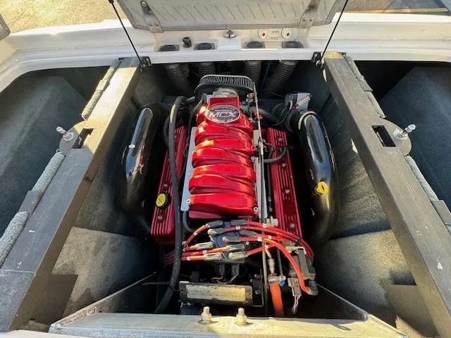 Slide: The Image of 2004 MasterCraft X-30 engine compartment with red engine components and open hatch. - 19
