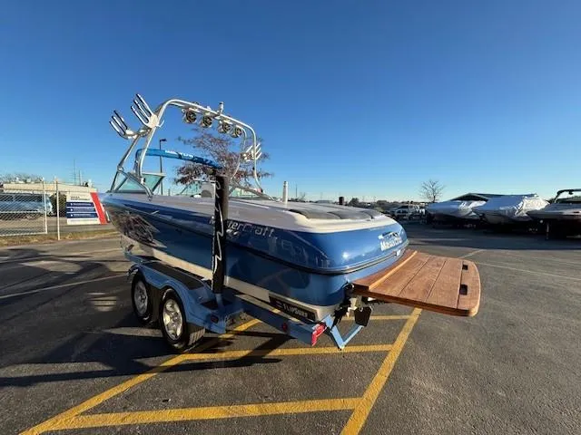 Slide: The Image of 2004 MasterCraft X-30 boat on trailer in parking lot, sunny day. - 5