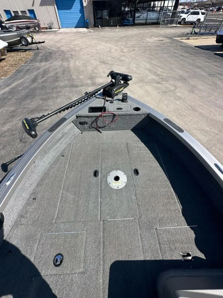 Slide: The Image of 2013 Crestliner Fish Hawk 1750 boat interior with trolling motor, parked on pavement. - 4