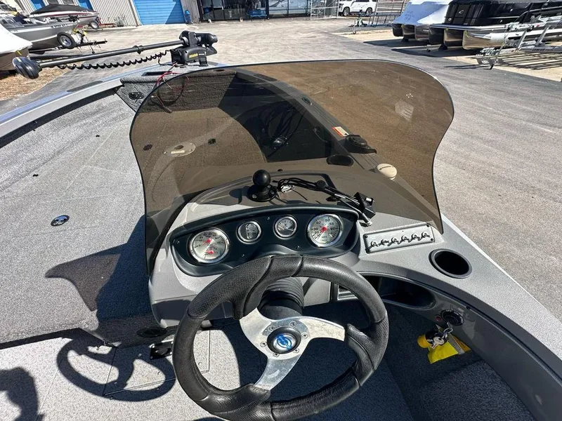 Slide: The Image of 2013 Crestliner Fish Hawk 1750 dashboard with steering wheel and gauges. - 9