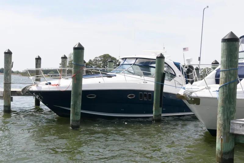 The Image of 2010 Sea Ray 390 Sundancer yacht docked at marina, side view. - 0