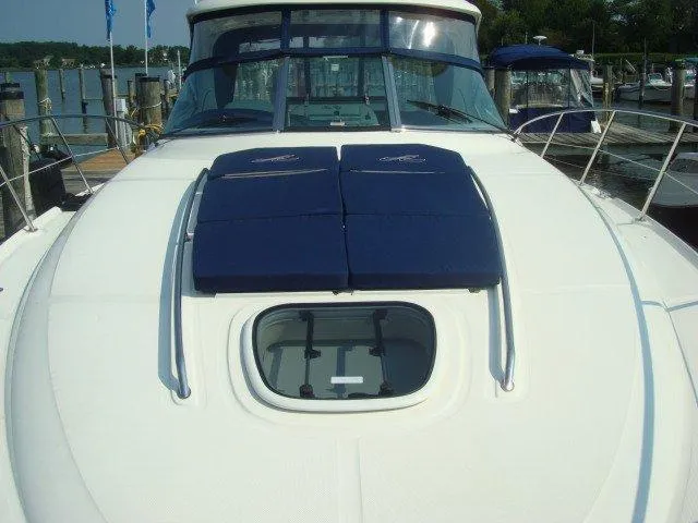 Slide: The Image of 2010 Sea Ray 390 Sundancer yacht with blue sun pads on deck, docked at marina. - 10