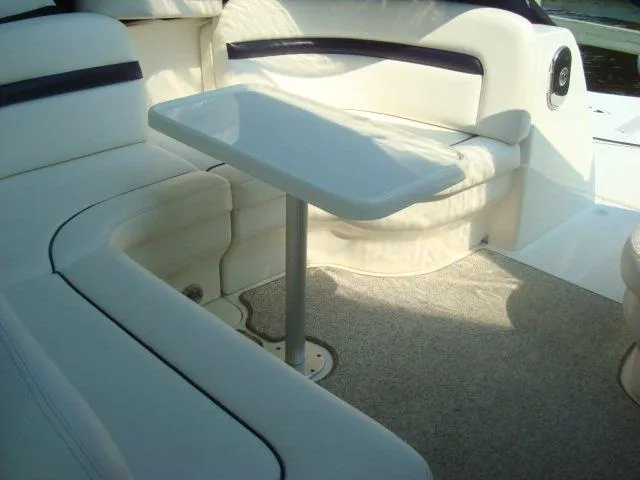 Slide: The Image of Interior seating area of 2010 Sea Ray 390 Sundancer with white upholstery and table. - 12