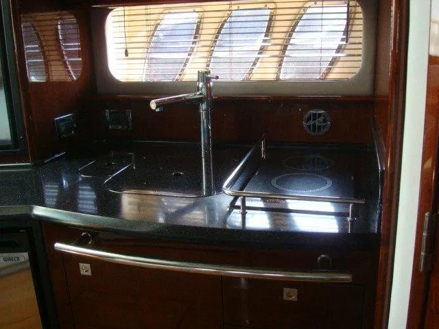 Slide: The Image of Luxurious kitchen area in a 2010 Sea Ray 390 Sundancer yacht with sleek countertops. - 15