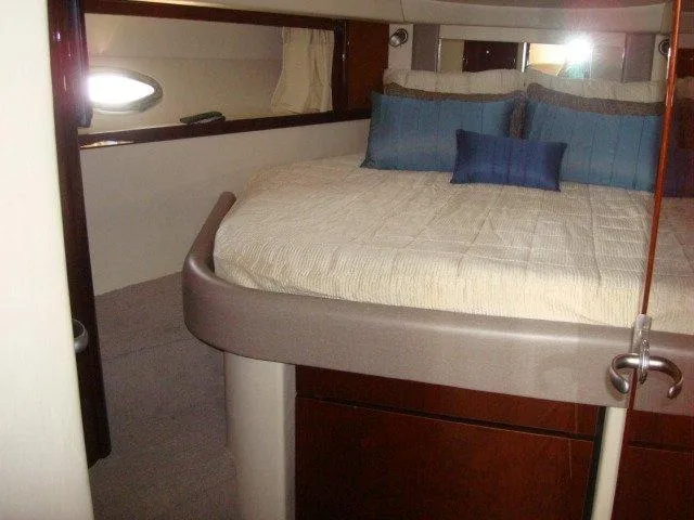 Slide: The Image of Interior cabin of 2010 Sea Ray 390 Sundancer with cozy bed and pillows. - 16