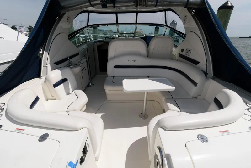 Slide: The Image of 2010 Sea Ray 390 Sundancer yacht interior with white seating and table. - 2