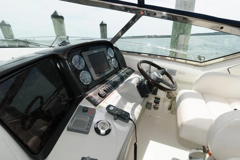 Slide: The Image of Cockpit of 2010 Sea Ray 390 Sundancer yacht with steering wheel and navigation instruments. - 5