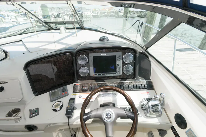 Slide: The Image of Cockpit of 2010 Sea Ray 390 Sundancer with navigation controls and steering wheel. - 6