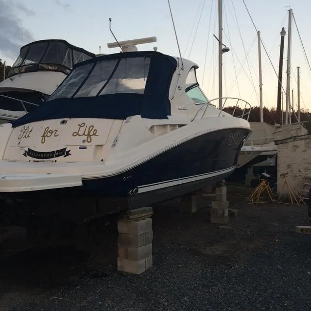 Slide: The Image of 2010 Sea Ray 390 Sundancer yacht on blocks, docked at a marina. - 7