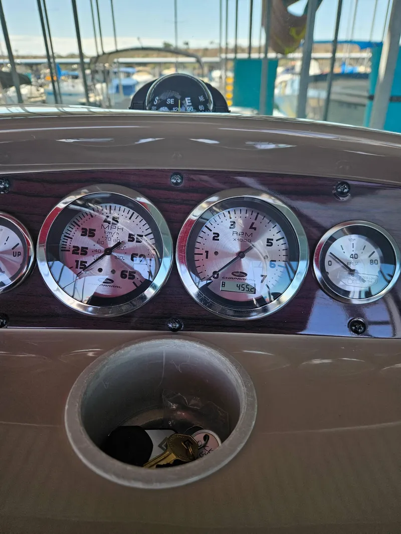 Slide: The Image of Dashboard of a 2003 Chaparral Sunesta 263 boat with gauges and keys. - 10