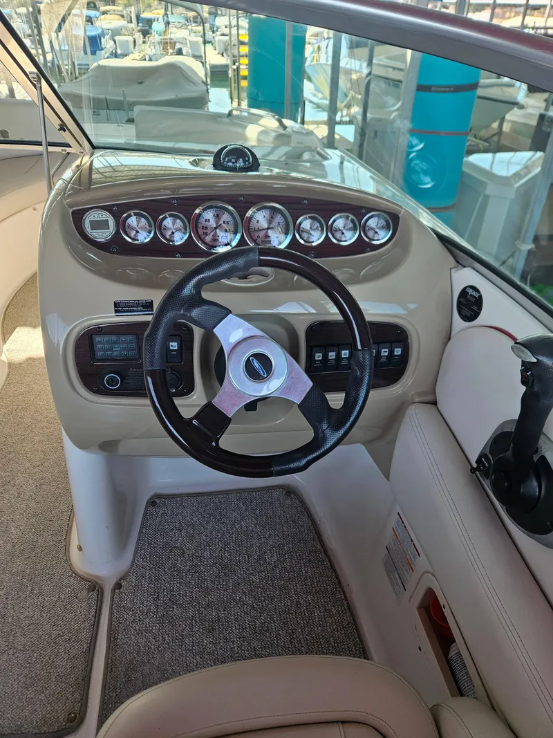 Slide: The Image of 2003 Chaparral Sunesta 263 boat dashboard with steering wheel and gauges. - 11