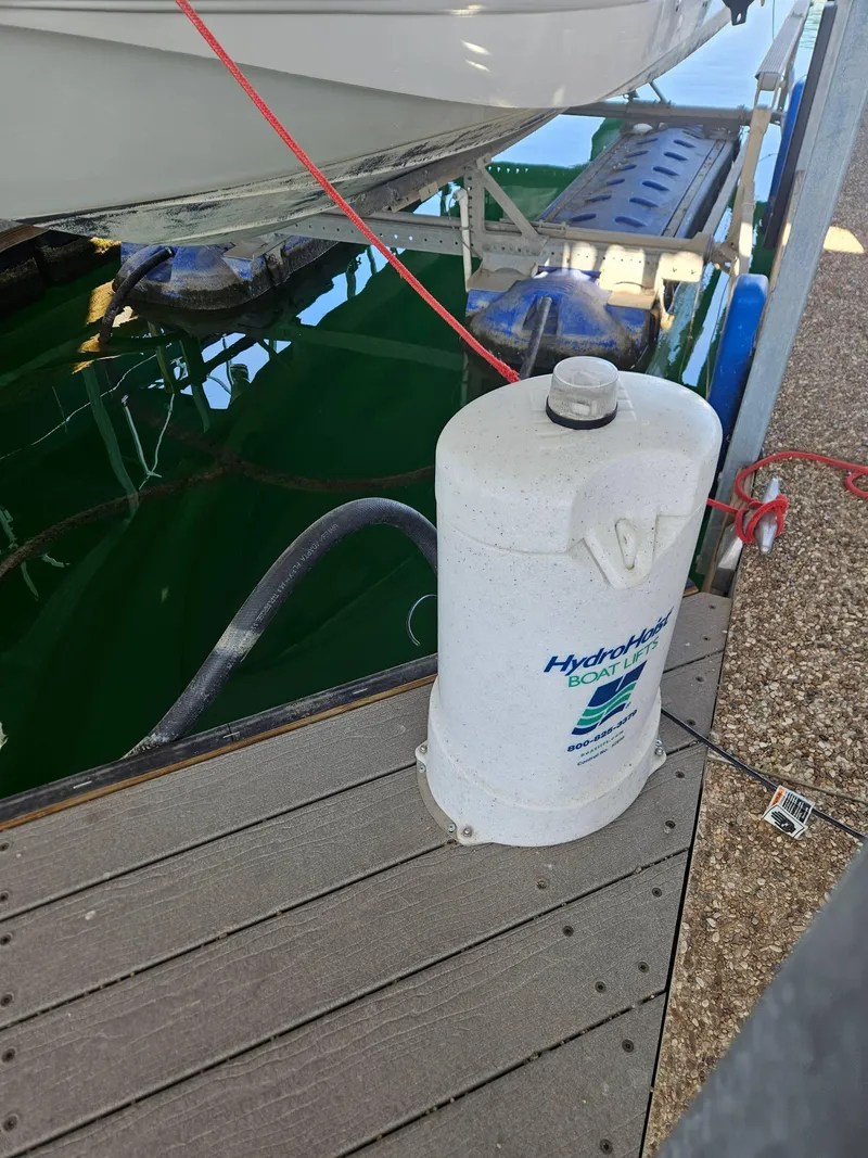 Slide: The Image of 2003 Chaparral Sunesta 263 on HydroHoist boat lift at dock. - 14